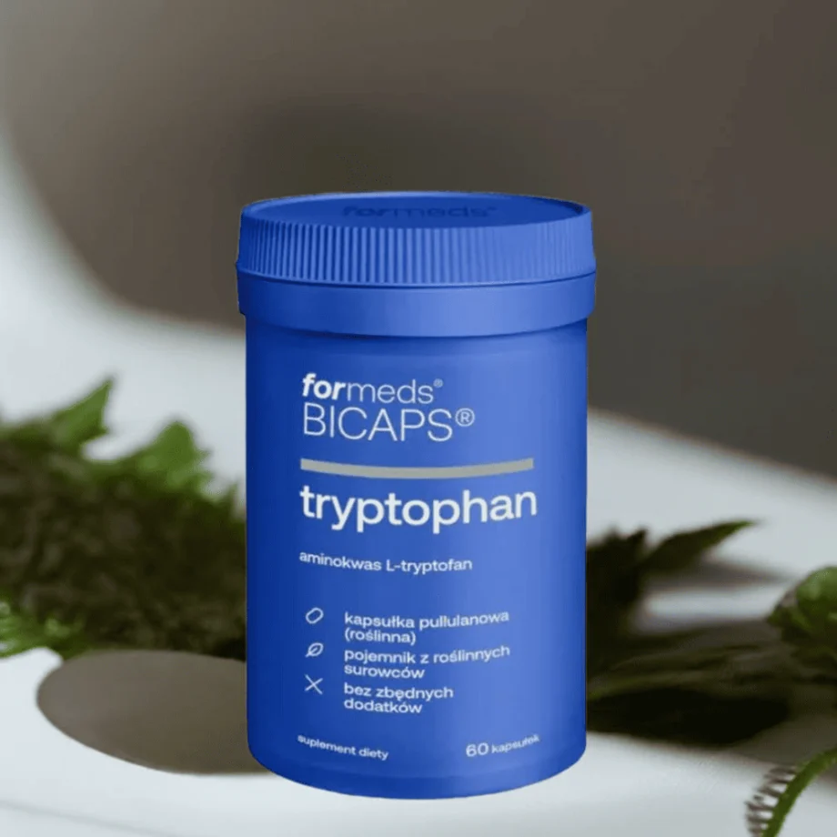 BiCaps Tryptophan - 500 mg czystego L-Tryptofanu w jednej kapsułce bez dodatków i wypełniaczy, opakowanie na tle marmurowej ściany z gałązkami roślin
