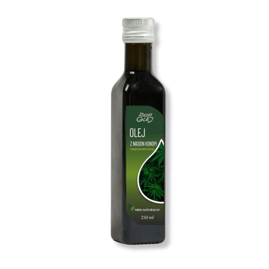 Butelka oleju konopnego Zielony Olej, otoczona roślinami konopi siewnych.