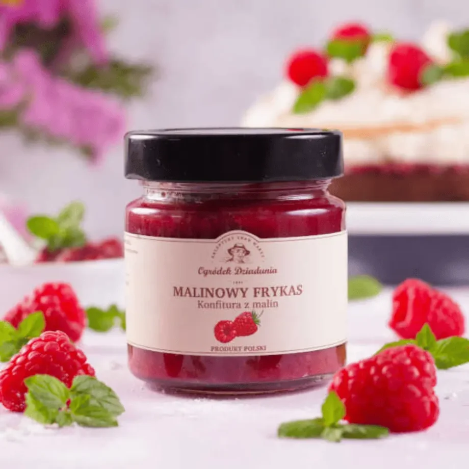 Konfitura malin na tle świeżych owoców maliny