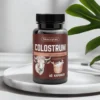 COLOSTRUM Skoczylas - polski suplement łączący wsparcie odporności i mikrobioty jelitowe, opakowanie na marmurowej podstawce