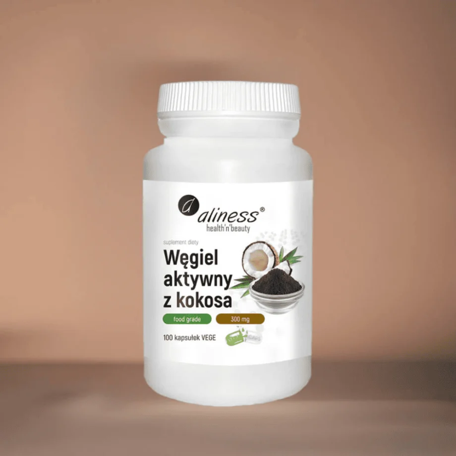 Kapsułki roślinne Vege z węglem aktywnym z kokosa Aliness 300 mg - wygodna forma suplementu oczyszczającego organizm z toksyn w opakowaniu na tle brązowej tkaniny